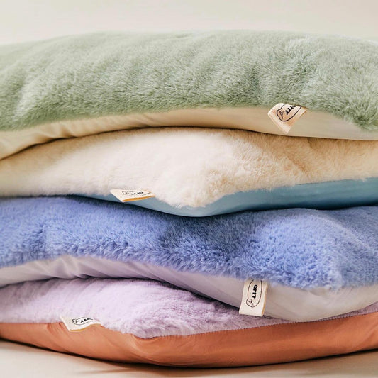 Arrr double-sided pet sleeping cushion in Pistachio, Creamy Blue, Cashmere Blue, and Lavender colours. One side features cool material, while the other side is made of soft warm material.